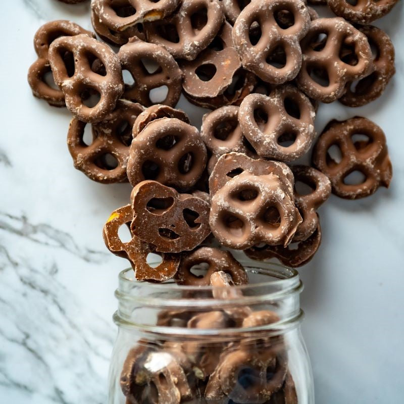 Chocolate Pretzels 13oz. l Take your snack game to the next level with these crunchy bow tie pretzels, smothered in a luscious layer of creamy milk chocolate. Perfectly salty, perfectly sweet—each bite is a satisfying combo of indulgence and crunch! $8.00 USD