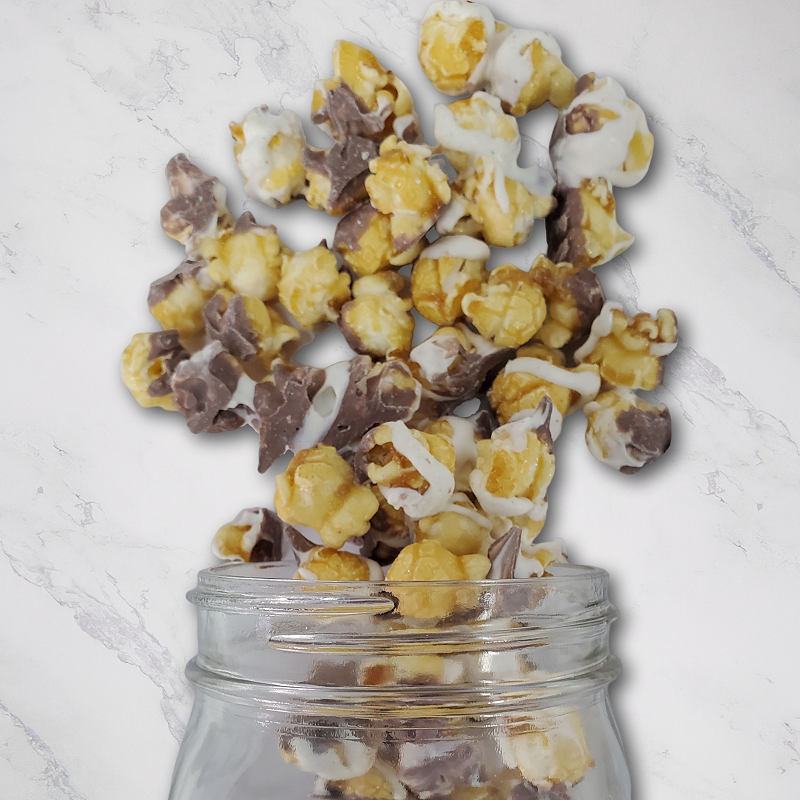 Marbled Corn 8oz. Indulge in the perfect blend of sweet and rich with classic caramel corn, topped with a luscious white coating and swirled with smooth milk chocolate. A treat that’s as irresistible as it is delicious! $6.00 USD