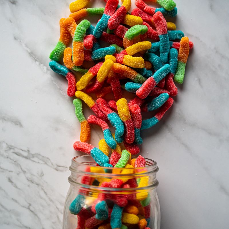 Neon Squiggles 14oz. Get ready for a tangy twist with these vibrant sour gummy worms! Bursting with fruity flavors and covered in sour sugar, they’re the perfect treat for your taste buds. $7.00 USD