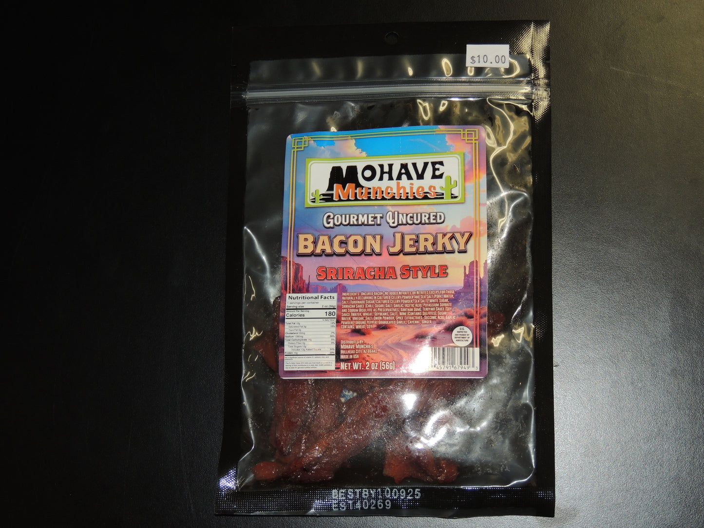 Sriracha Style Bacon Jerky - 2oz. A Thai-Inspired Snack with Bold Heat! Made with premium bacon, hot sriracha sauce, and a blend of choice ingredients, this jerky is packed with flavor and heat. $10.00 USD