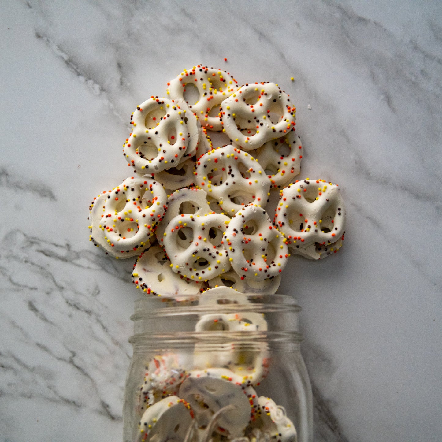 harvest sprinkled pretzels 13oz. Dive into the fall vibes with our delicious Harvest Sprinkled Pretzels! These crunchy pretzels are coated in creamy white confection and topped with festive, colorful sprinkles. Perfect for any fall celebration! $10.00 USD