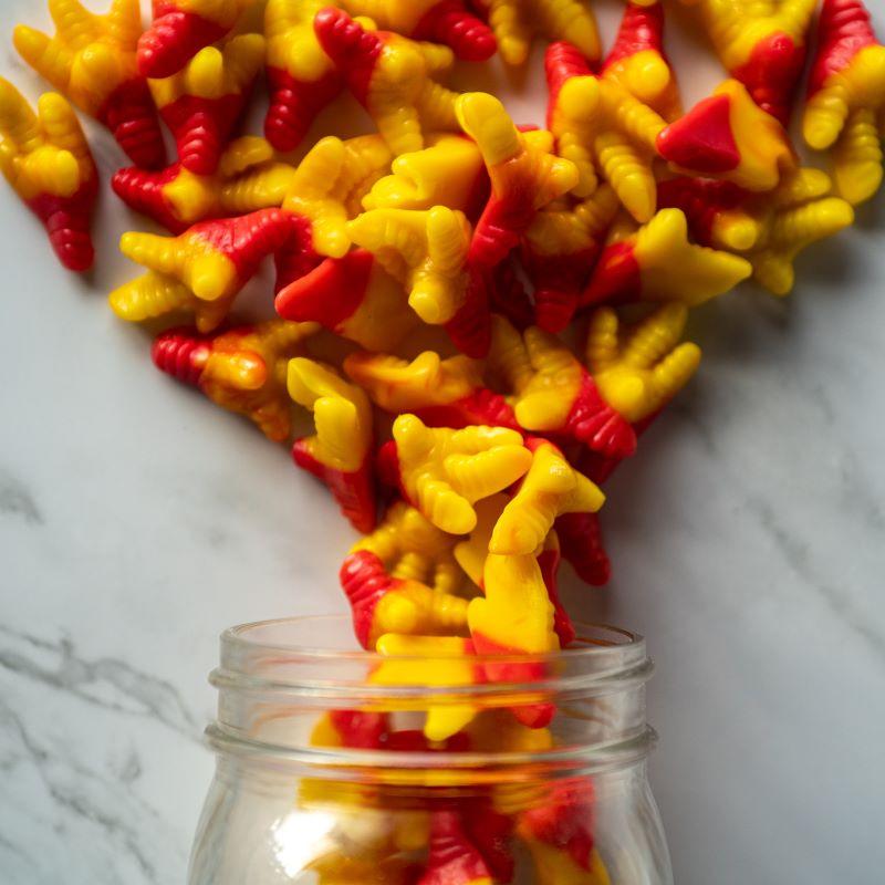 Gummy Chicken Feet 13oz. A little bit crazy, but a whole lot of fun! These vibrant yellow and red gummy chicken feet are bursting with a fruity punch flavor that will keep you coming back for more! $7.00 USD