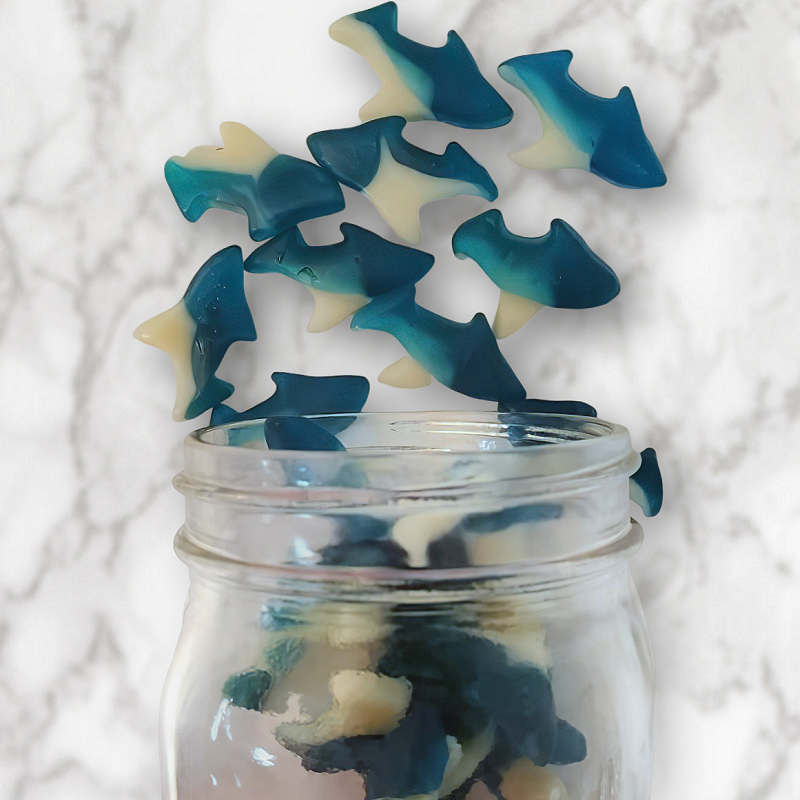 Gummy Sharks 14oz. Dive into the ocean of flavor with these fun and fruity gummies that look just like sharks! With the refreshing taste of a Firecracker Popsicle (cherry, lemon-lime, and blue raspberry), these ocean-teal gummies are a sweet and playful treat. Perfect for kids and adults alike, they’re sure to make a splash! $6.00 USD