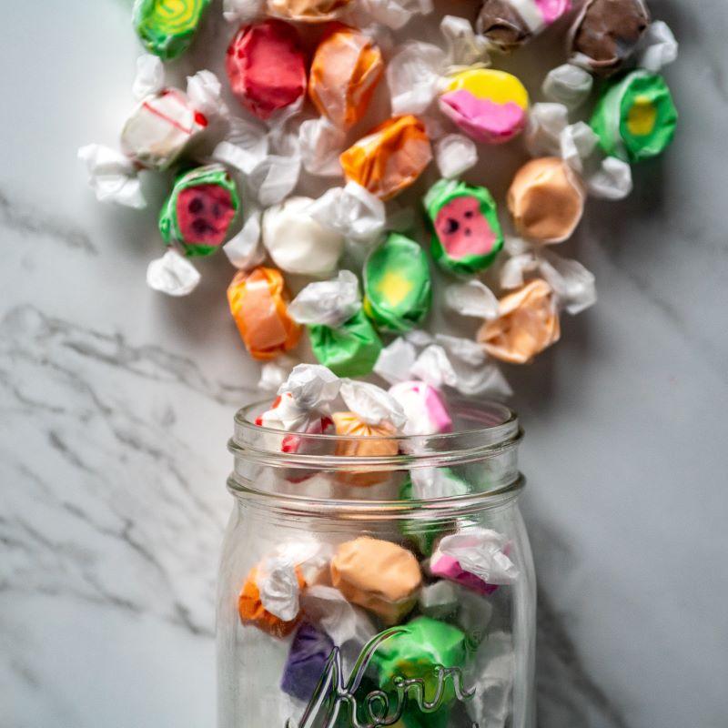 Salt Water Taffy 16oz. Take a sweet trip down memory lane with this classic old-time favorite! Our Salt Water Taffy comes in a variety of mouth-watering flavors, from rich chocolate to zesty lemon and refreshing peppermint. Perfectly chewy and full of nostalgic sweetness, you’ll want to enjoy it again and again. $8.00 USD