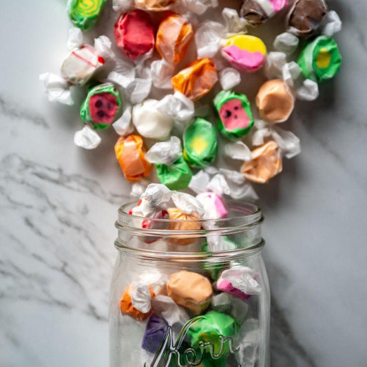 Salt Water Taffy 16oz. Take a sweet trip down memory lane with this classic old-time favorite! Our Salt Water Taffy comes in a variety of mouth-watering flavors, from rich chocolate to zesty lemon and refreshing peppermint. Perfectly chewy and full of nostalgic sweetness, you’ll want to enjoy it again and again. $8.00 USD