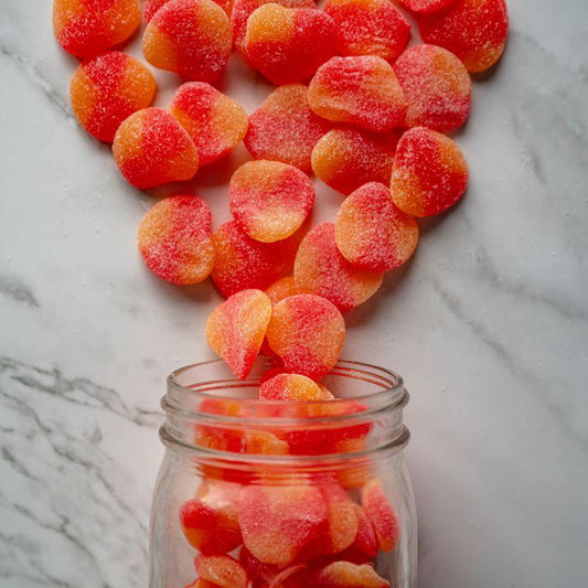 sanded gummy peaches 14oz. Sugar-sanded gummy peaches that are irresistibly soft and bursting with fruity sweetness. These juicy gummies are perfect for a refreshing treat! $7.49